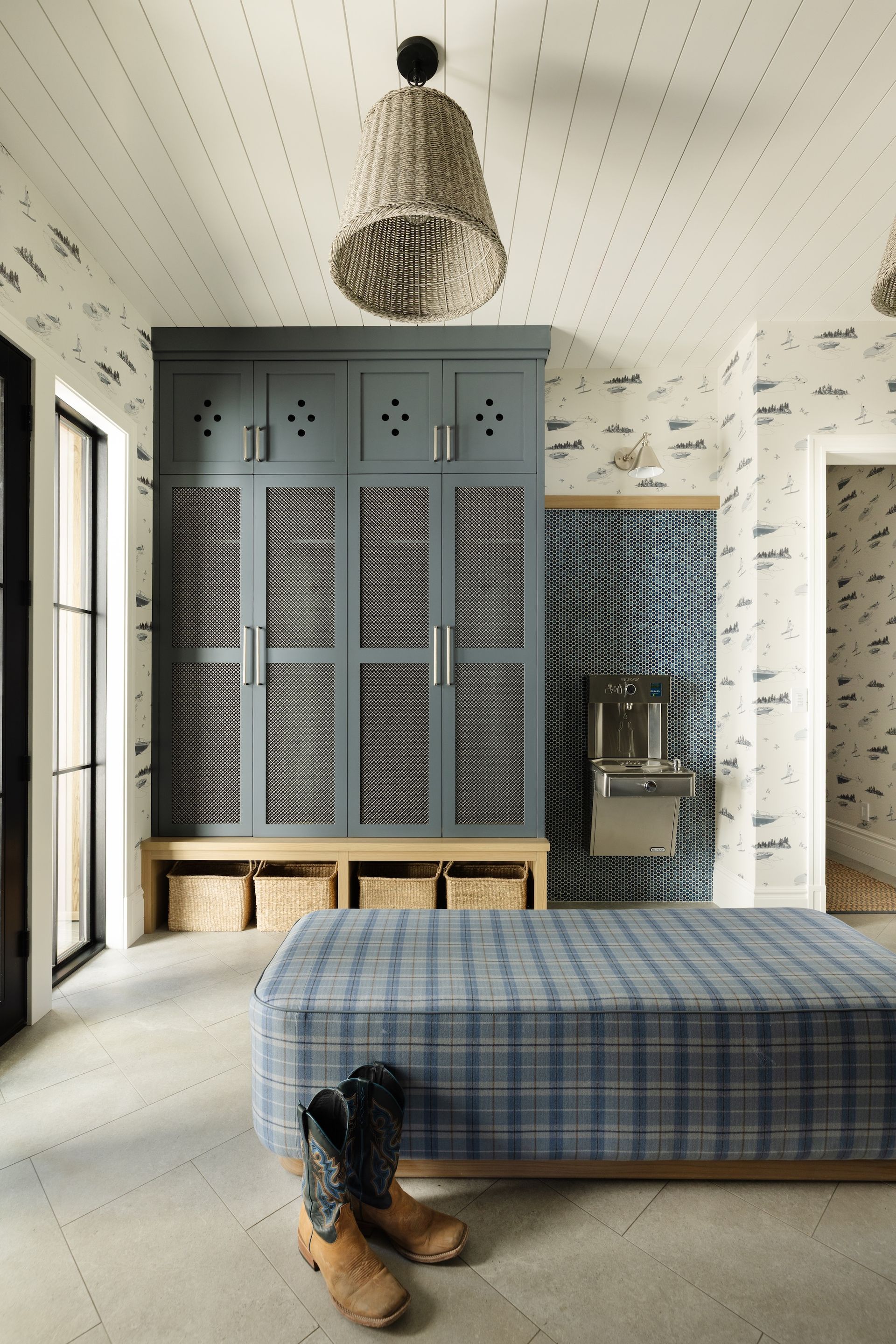 Cozy bedroom with blue bed, gray wardrobe, patterned ceiling, and boots on the floor.