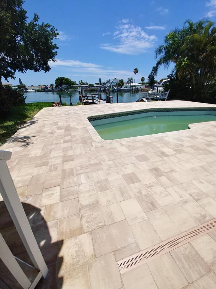 Patio with a small pool overlooking a calm waterfront under a blue sky in Tampa Bay, Florida