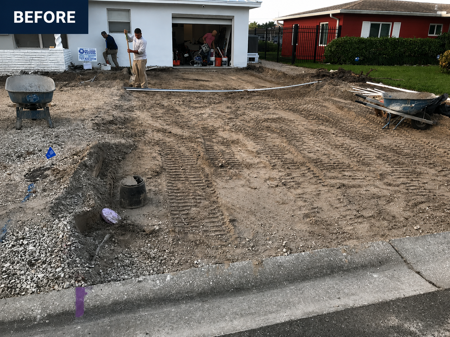 Before view of a house front yard being graded, with a worker and exposed dirt driveway.