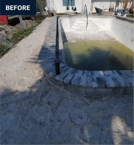 Empty pool with dirty water and a sandy deck beside a building, labeled “BEFORE”