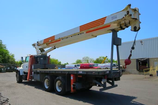 Boom truck in a parking lot ready for crane service