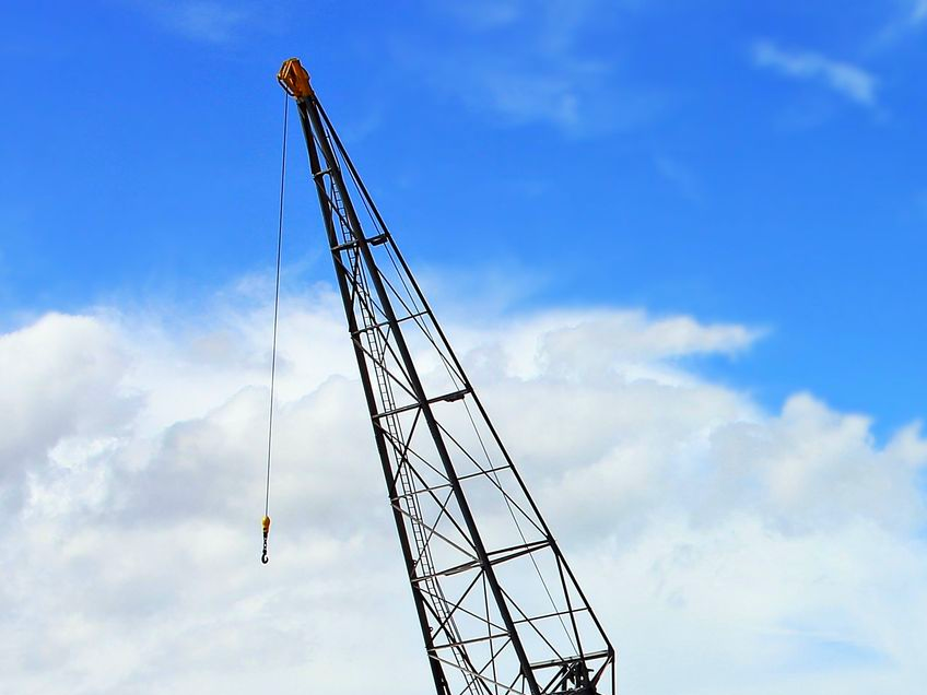 The top of a crane with the sky in the background