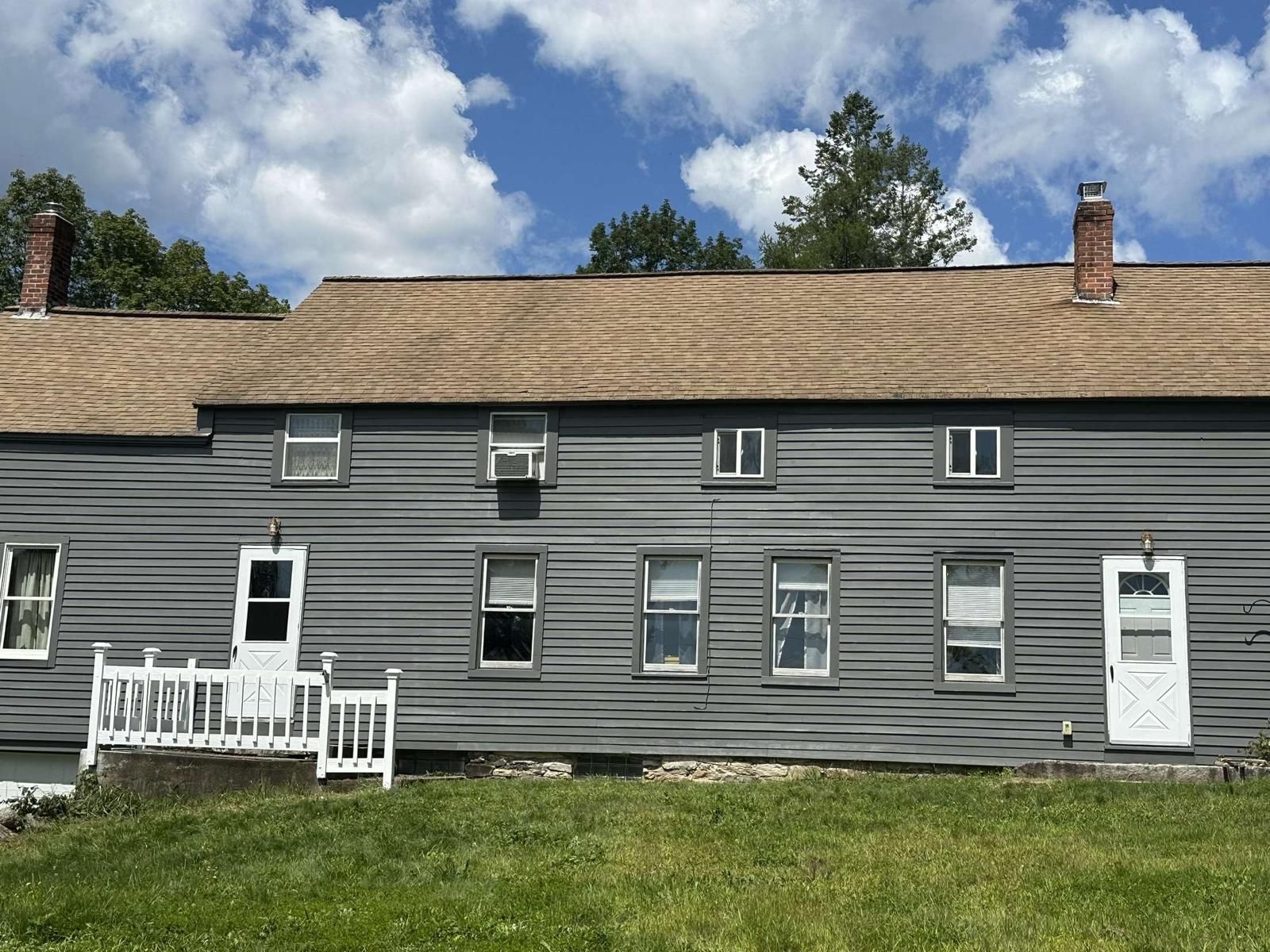 A large house with a roof that is covered in shingles