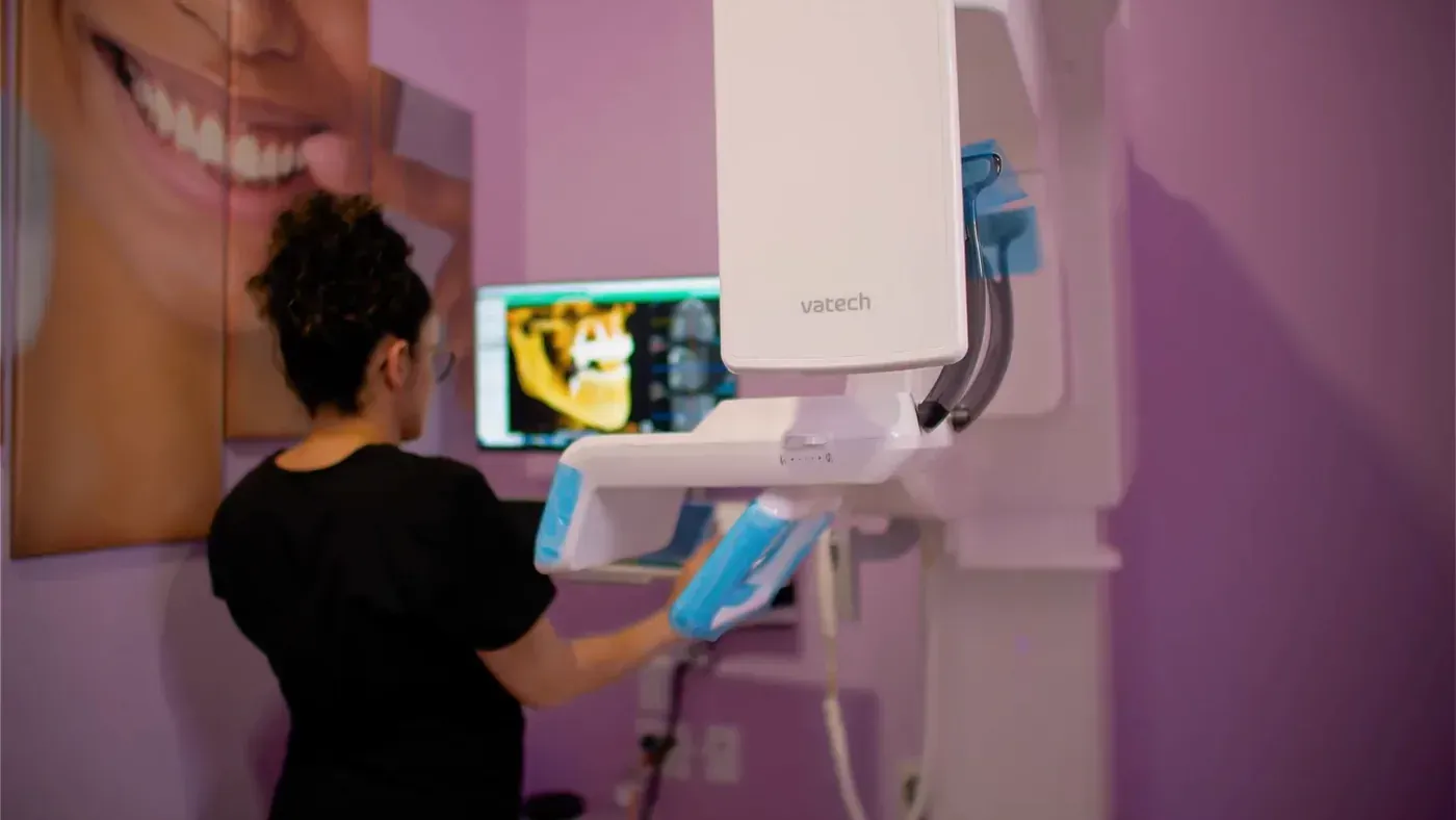 Team member at the 3D cone beam CT scanner used to plan a sinus lift