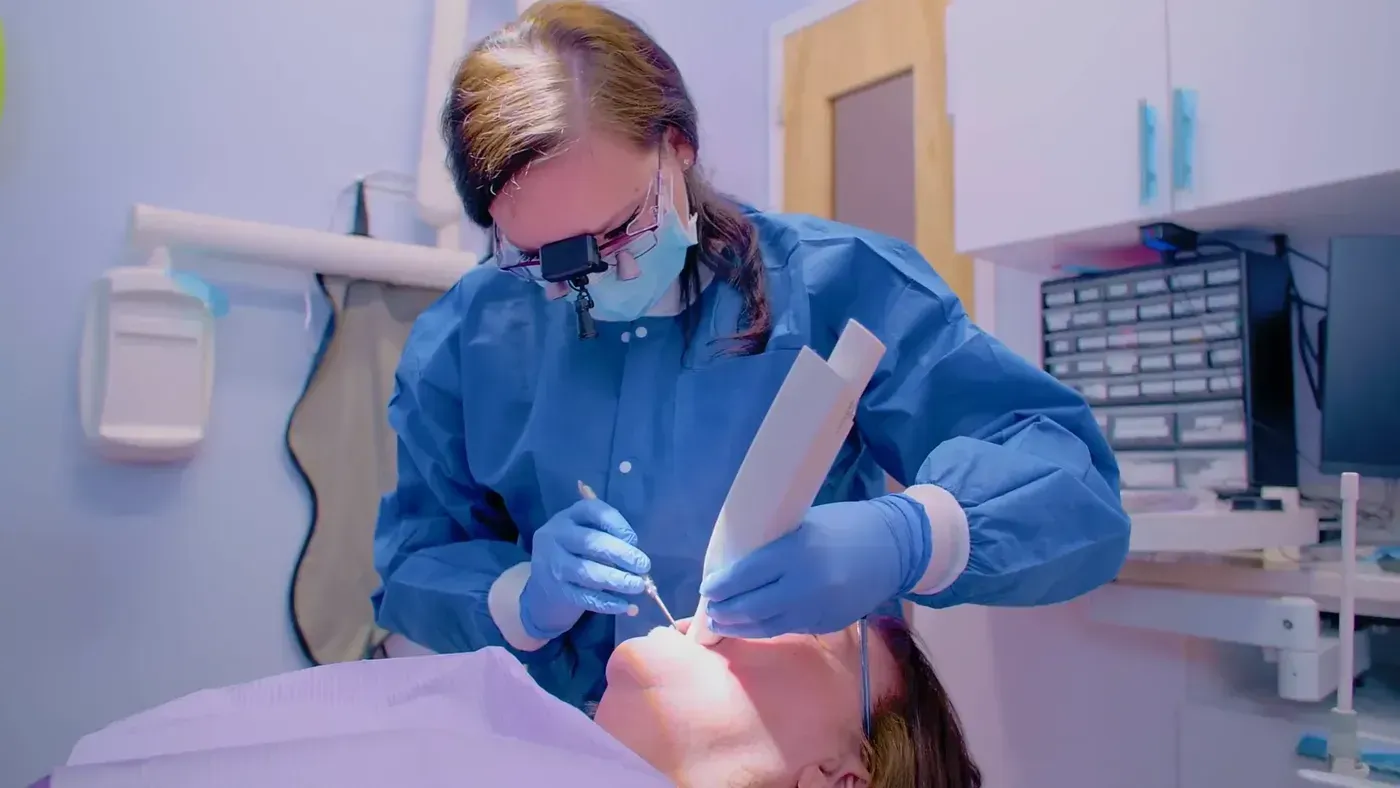 Deep Cleaning: hygienist examining a patient with loupes
