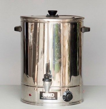 Stainless steel beverage urn with spigot and black lid knob on a plain background