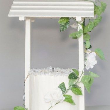 White decorative well with flowers and green vines on a gray background