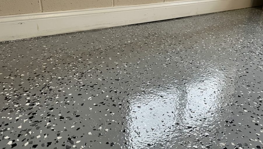 Close up detail of decorative color flakes sealed under a clear, glossy epoxy topcoat.