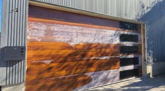 A close up of a garage door with a painting on it.