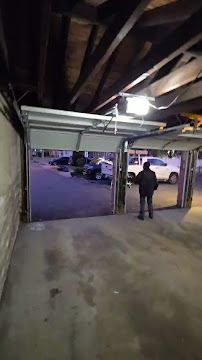 A man is walking into a garage with the door open.