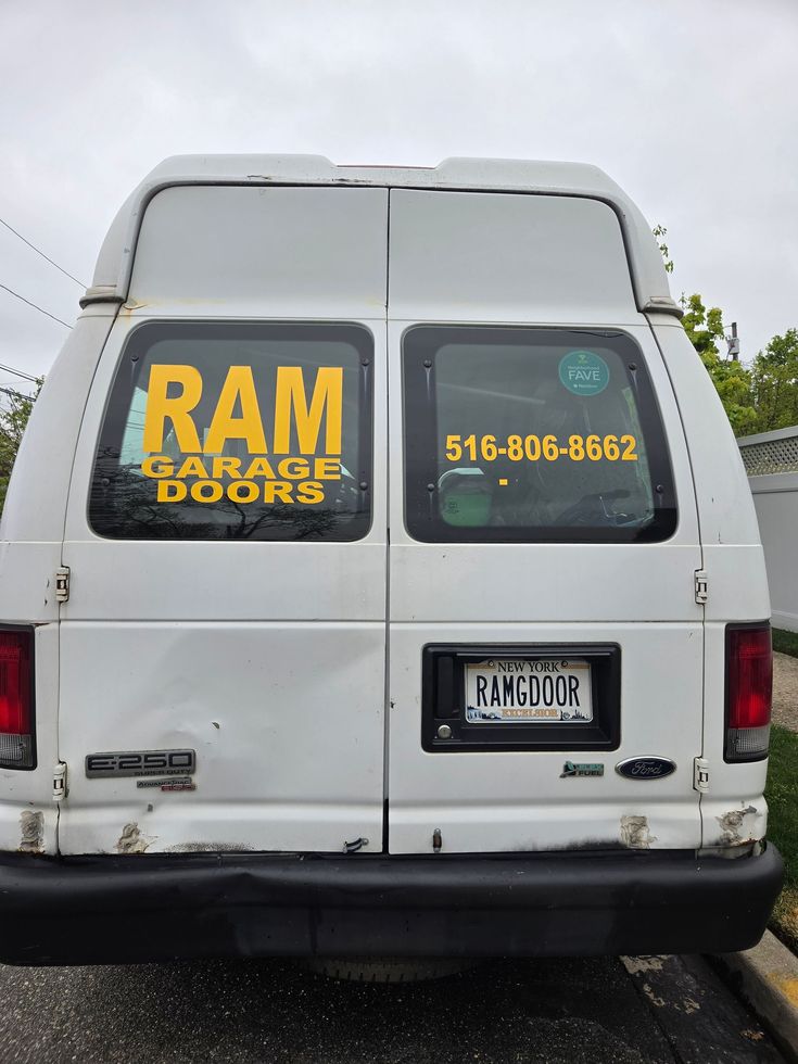 White RAM Pro’s Doors van rear with yellow logo, phone number, and license plate visible