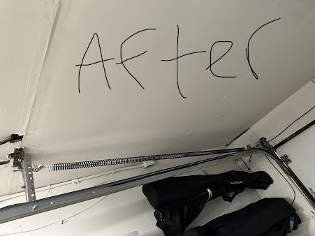 A garage door with the word after written on it.