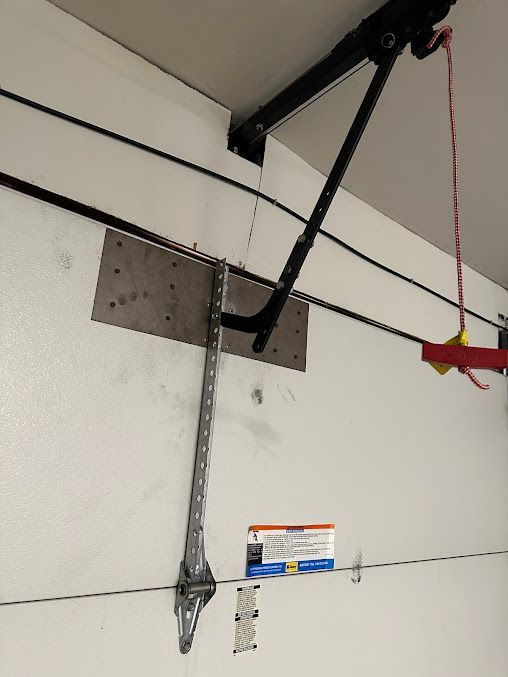 A garage door opener is hanging from the ceiling