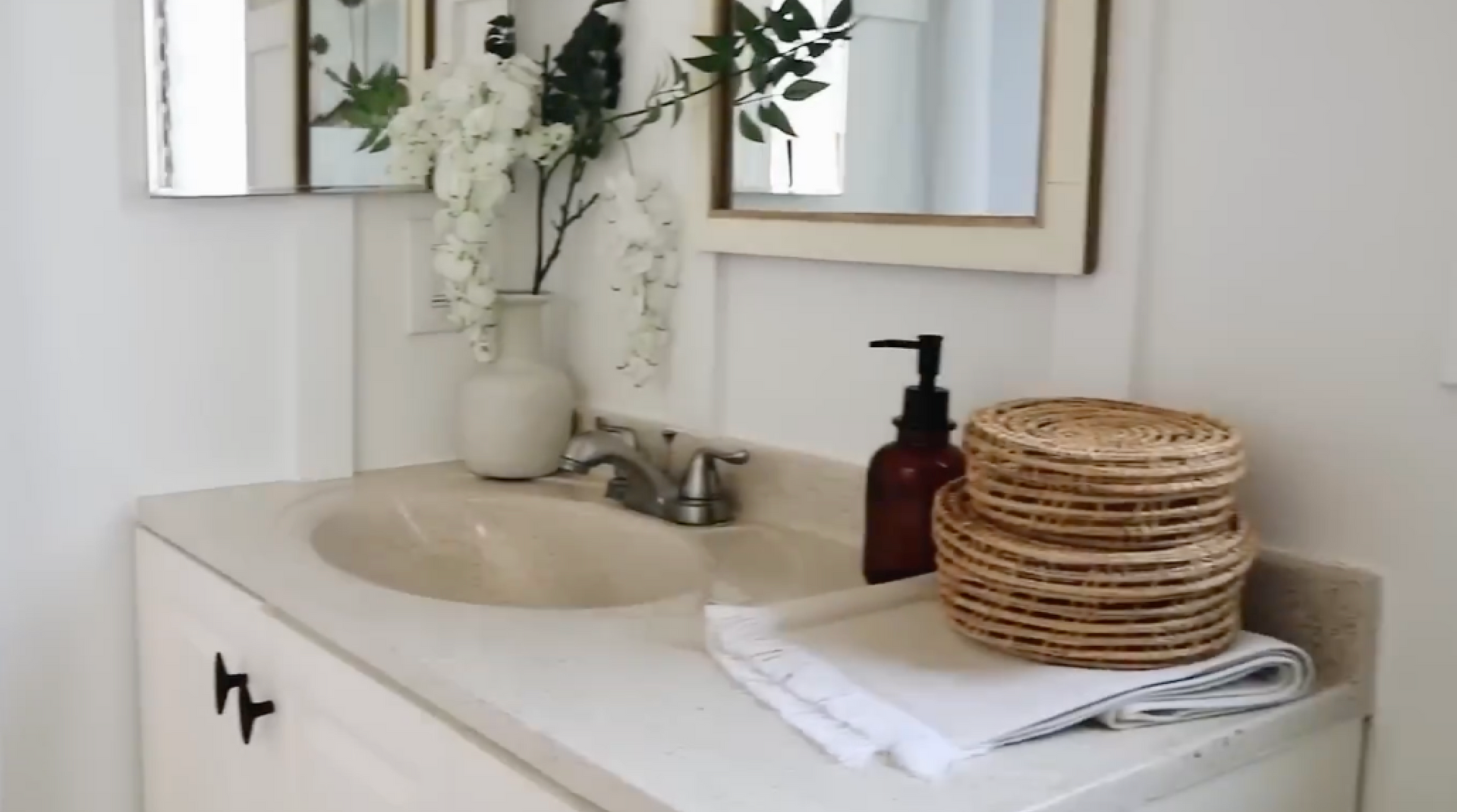 Clean and streamlined sink with vanity, installed to give the bathroom an updated refresh with both appearance and storage.