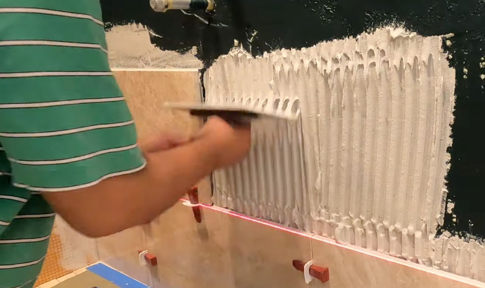 Contractor apply plaster to prepare for installation of shower wall tiles, necessary step for preventing water damage