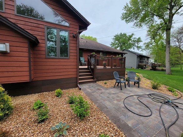A house with a patio and chairs in front of it.