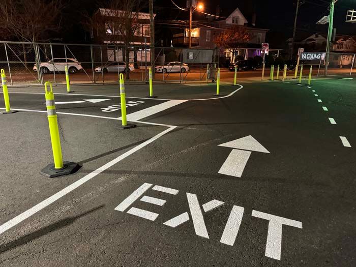 Asphalt lot with painted white directional arrows and 