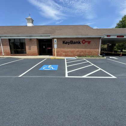 Exterior of a KeyBank branch with accessible parking. Brick building with an ATM drive-thru.