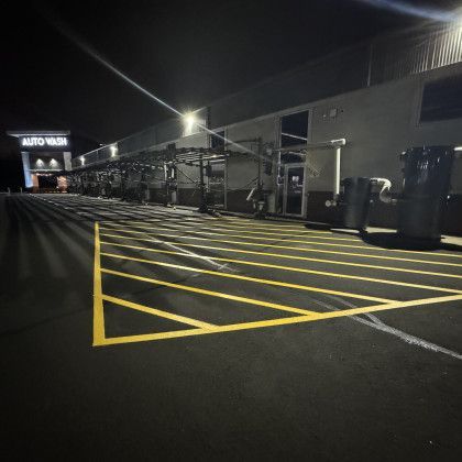 Car wash at night with yellow parking lines.