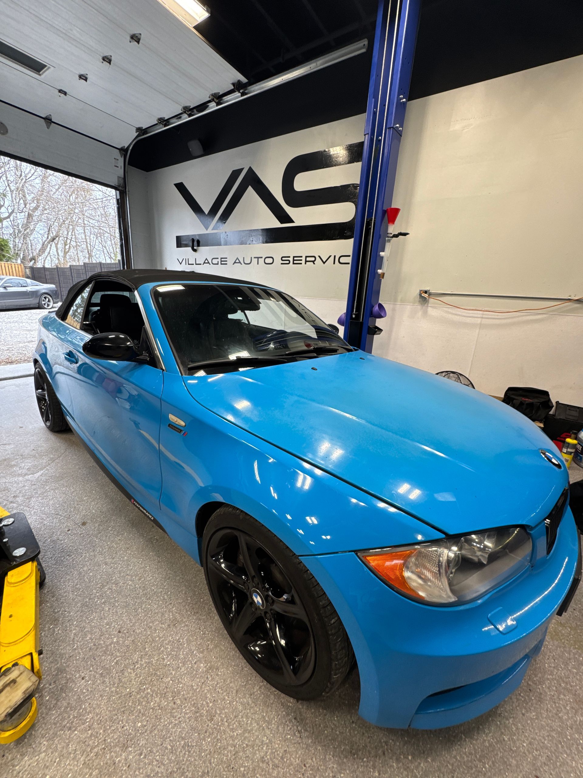 A blue BMW is parked in our Ancaster auto repair shop for tire and fuel system service