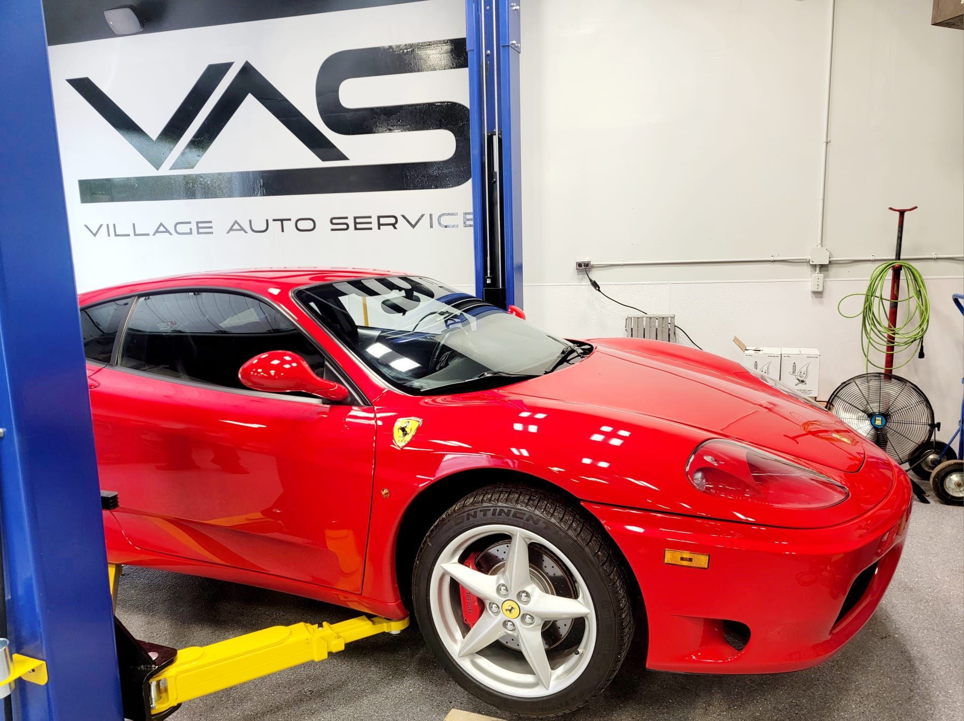 Red Ferrari in for maintenance at Village Auto Service