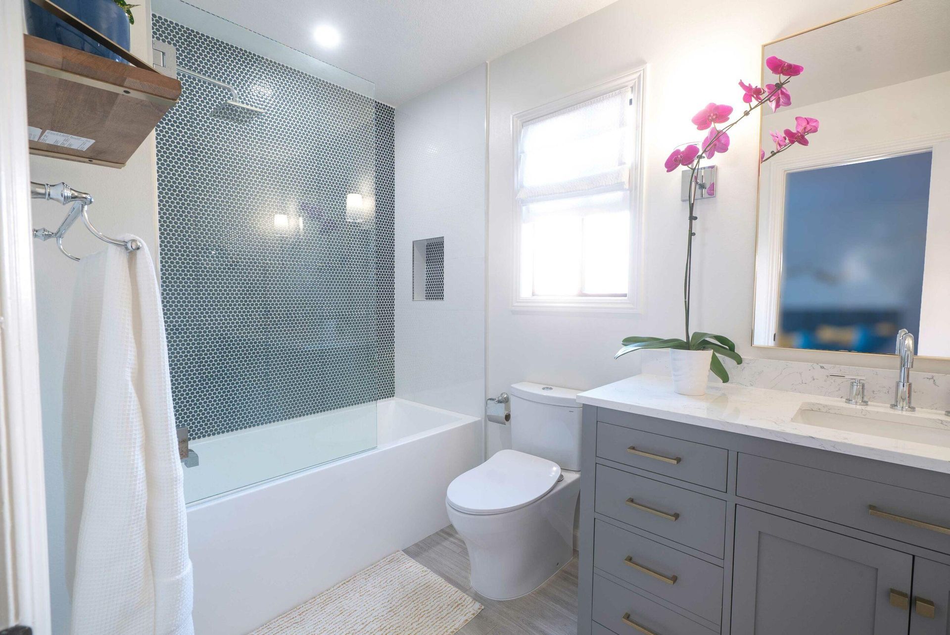 A bathroom with a toilet , sink , and bathtub.