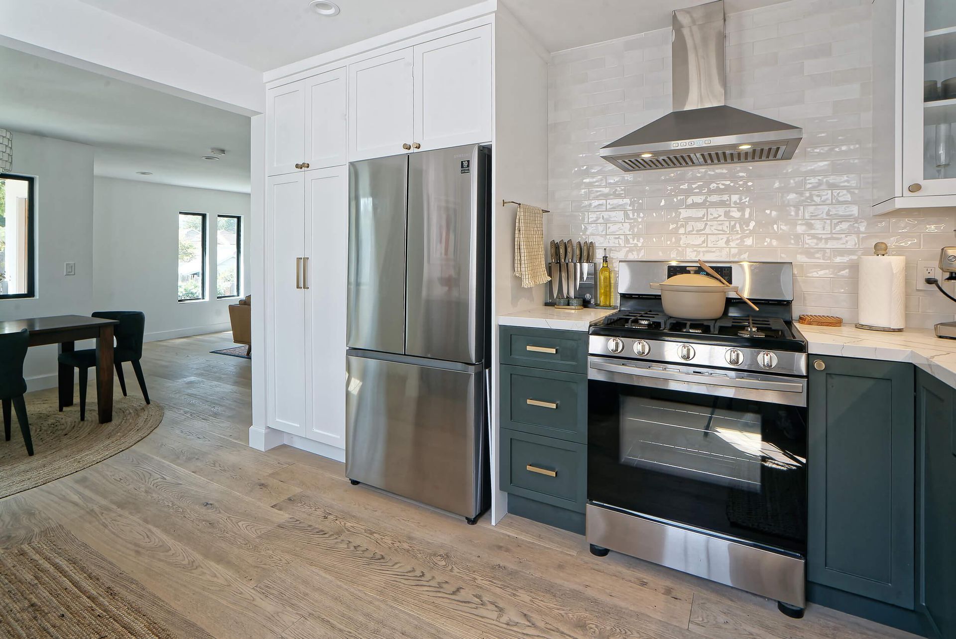A kitchen with stainless steel appliances and white cabinets