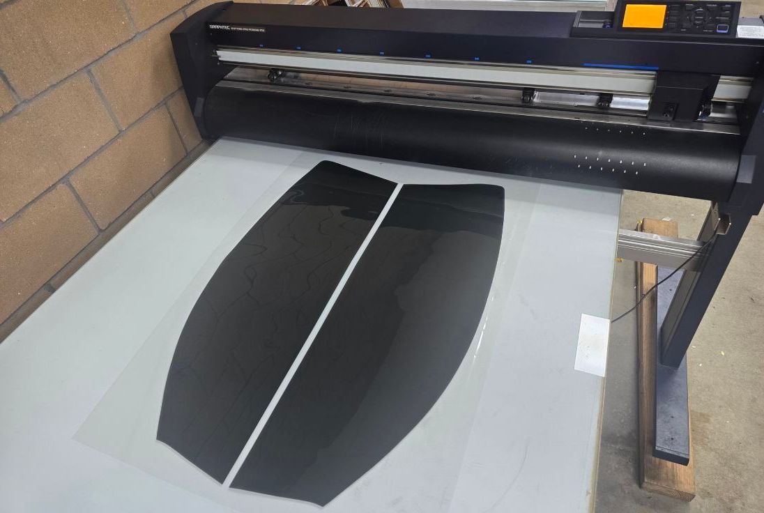 A machine that is cutting a piece of paper