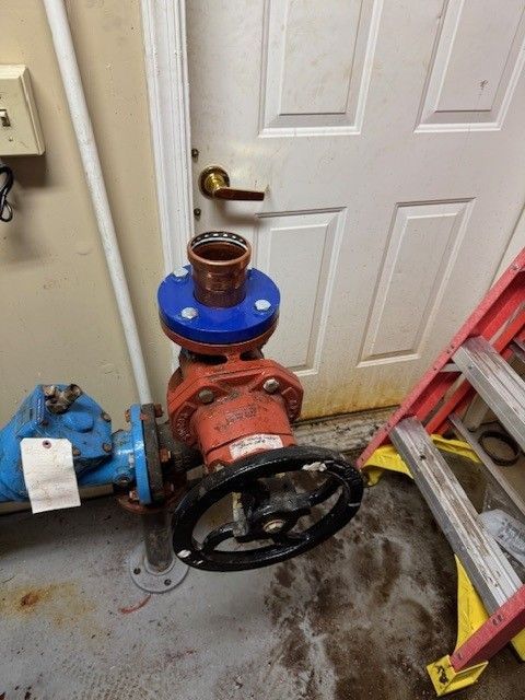 a red, 3inch commercial line with black spin wheel, blue pipes, and blue and copper connection