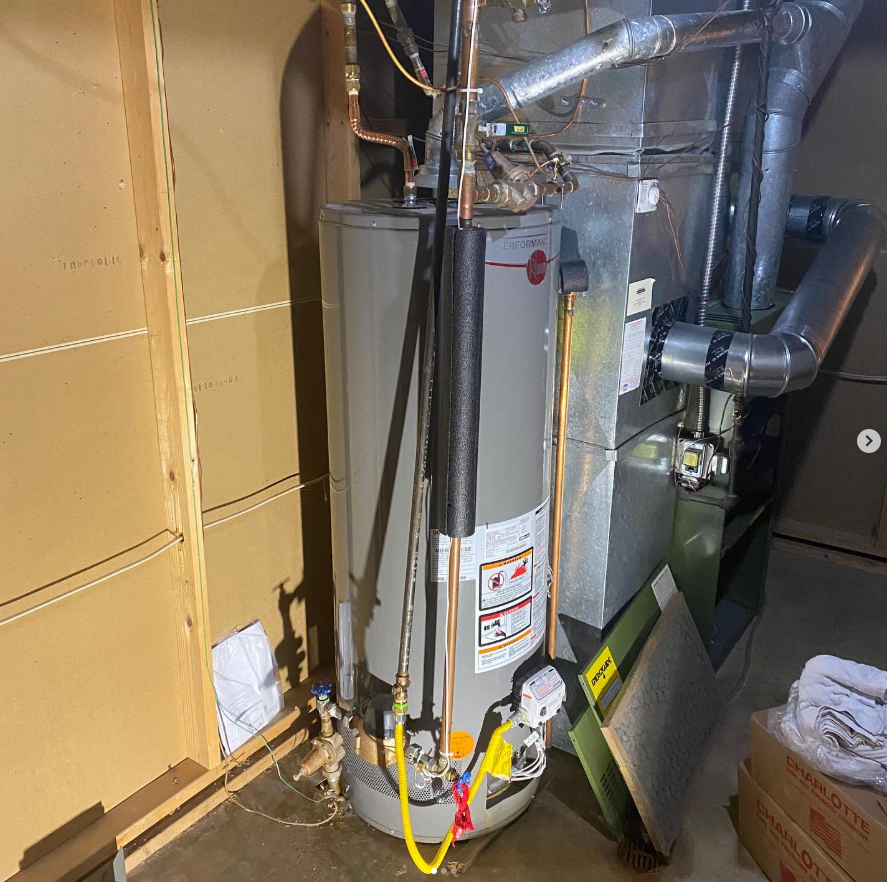 Water heater with insulated pipes and venting in a cramped utility closet