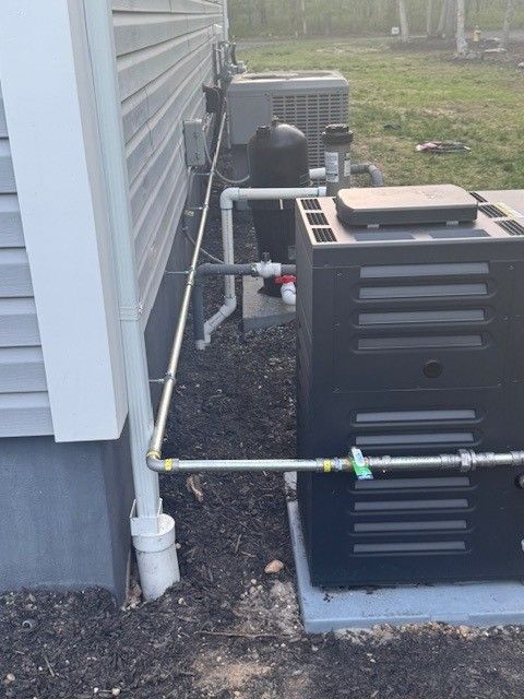 Exterior of a building with HVAC units with a new gas line connected for a pool heater