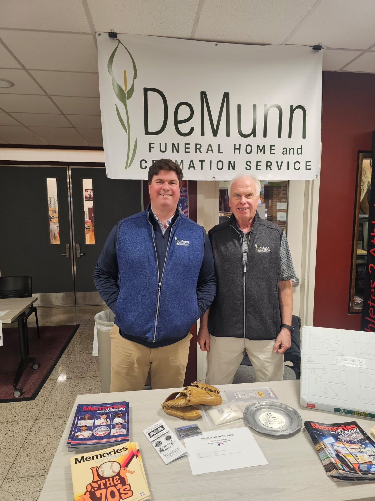Representatives from Demunn Funeral Home and Cremation Service at a men's basketball game