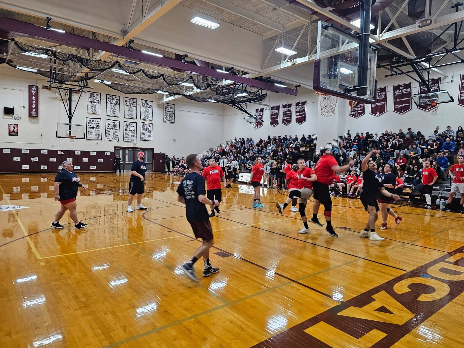 Men playing basketball in a high school gym