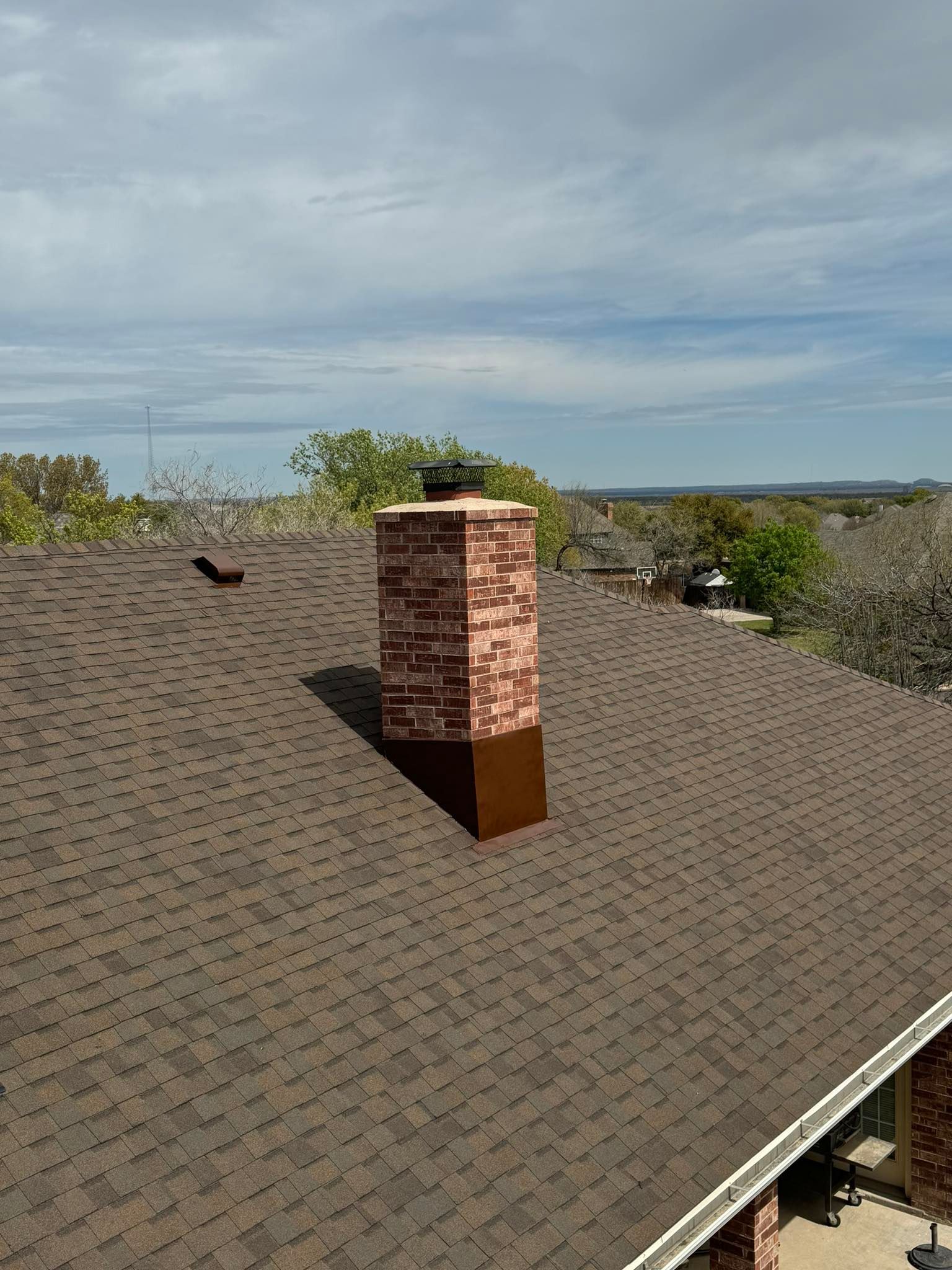 A chimney is on the roof of a house.