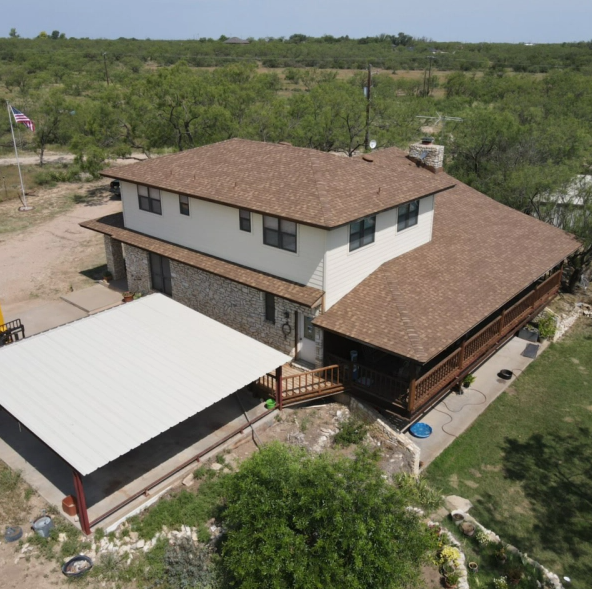 An aerial view of a house with a brown roof