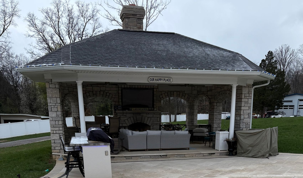 Brick masonry fence with pilasters and louvered panels