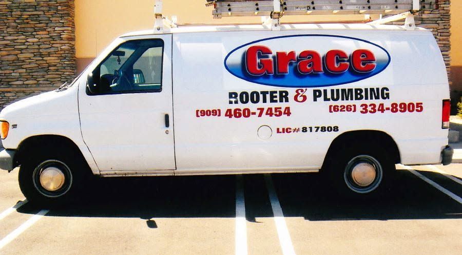 White Grace Rooter & Plumbing van parked in a lot.