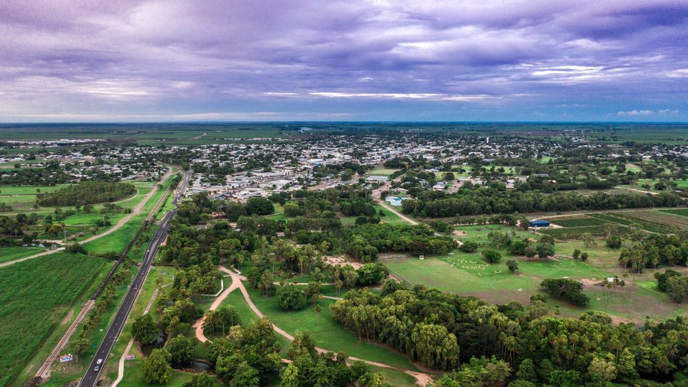 An aerial view of a small town surrounded by trees and fields — Lynams Landscapes Pty Ltd in Mount Louisa, QLD