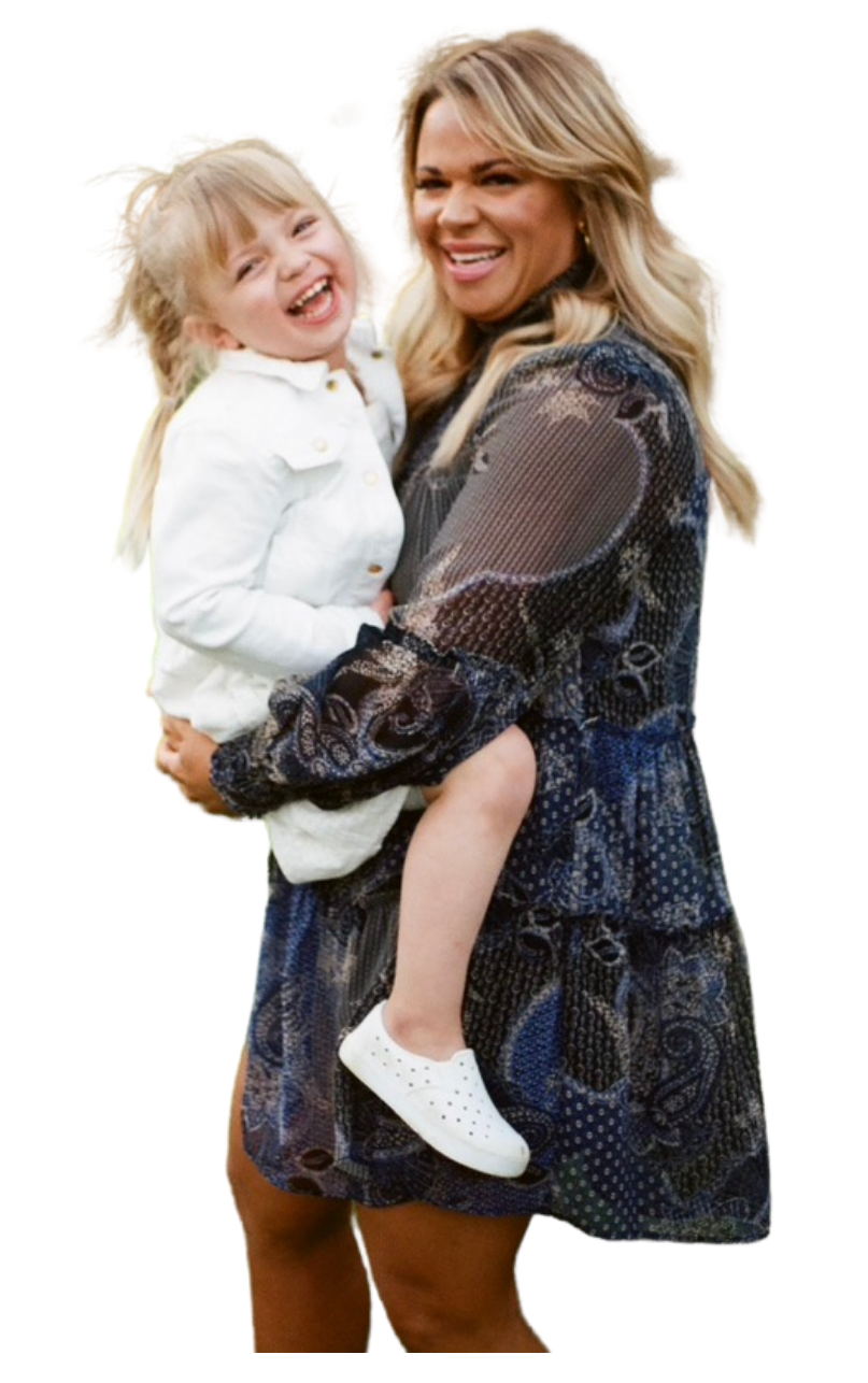 A woman is holding a little girl in her arms.