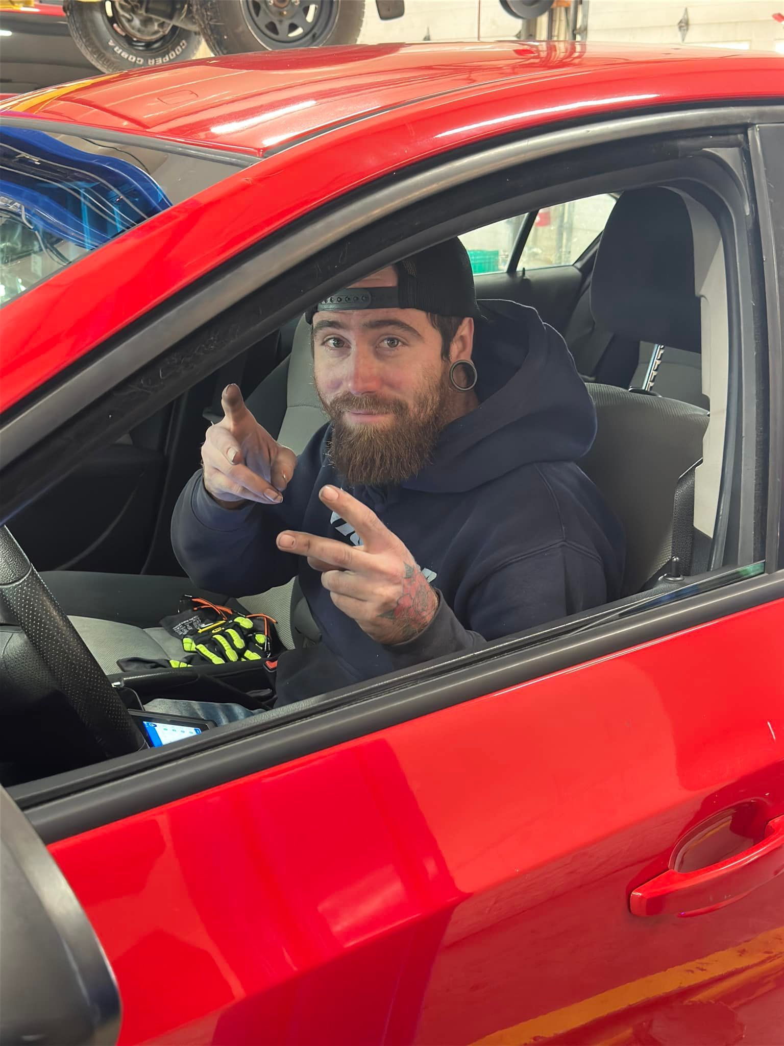 Shop Staff Inside a Car | Airbase Automotive Repair Inc