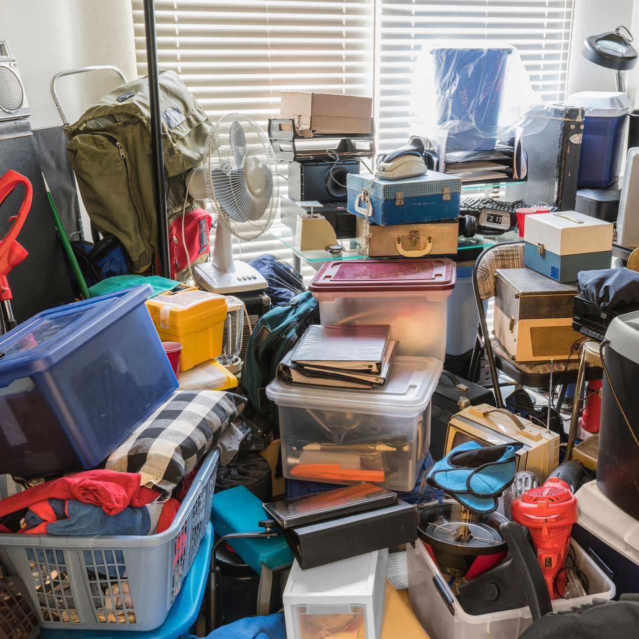 A room filled with lots of boxes and clothes.