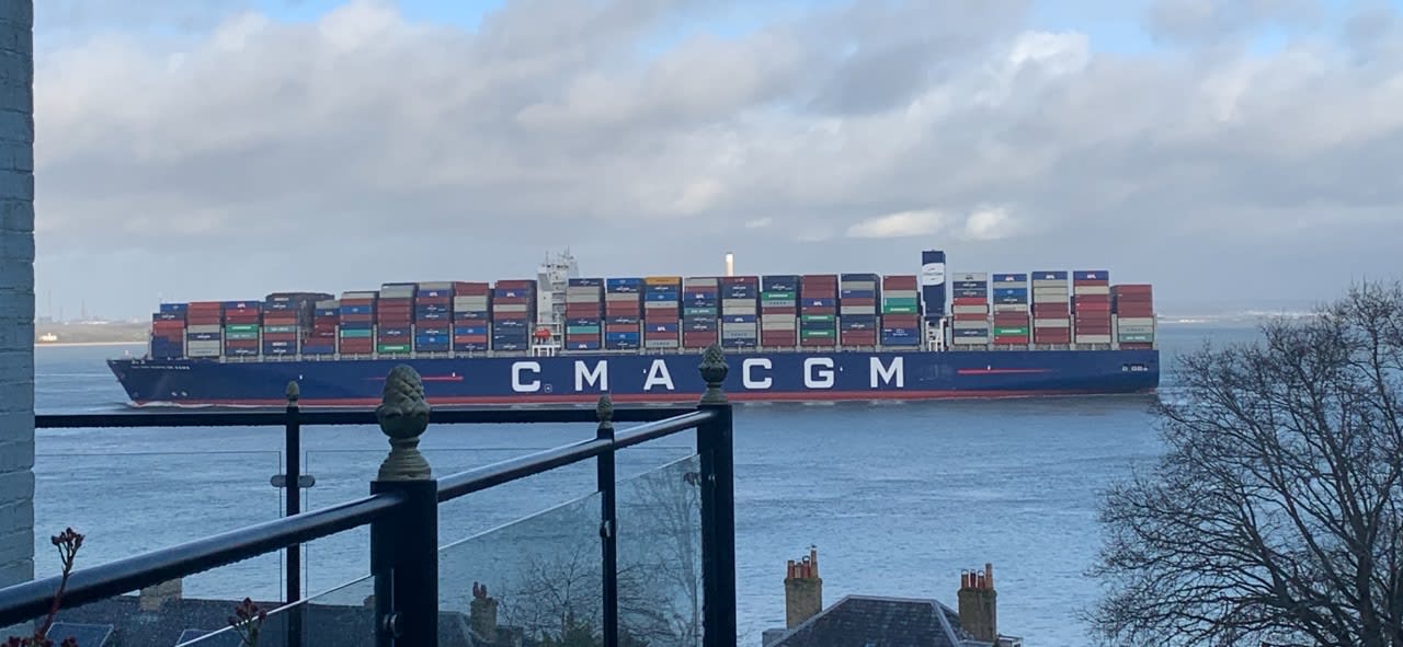 A large cargo ship, blue with the letters 