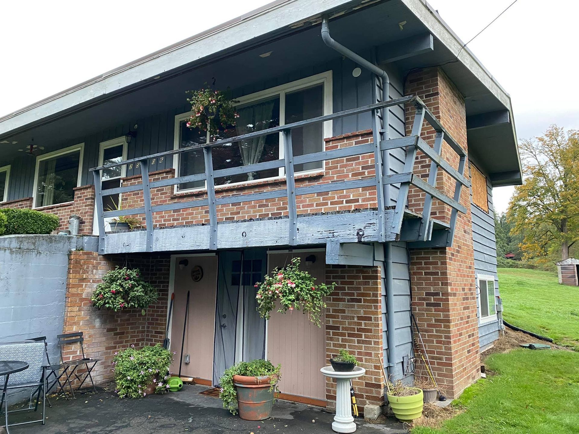 A large brick house with a balcony on the second floor.