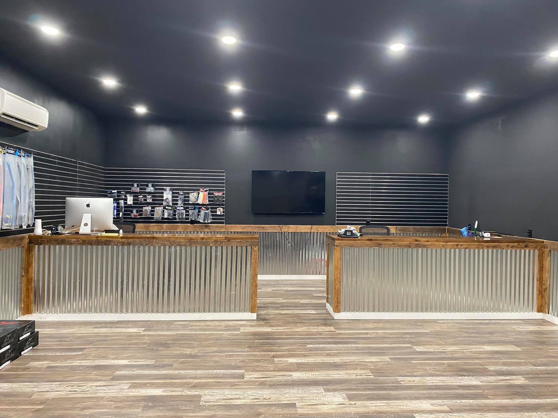 The inside of a store with a metal counter and a wooden counter.