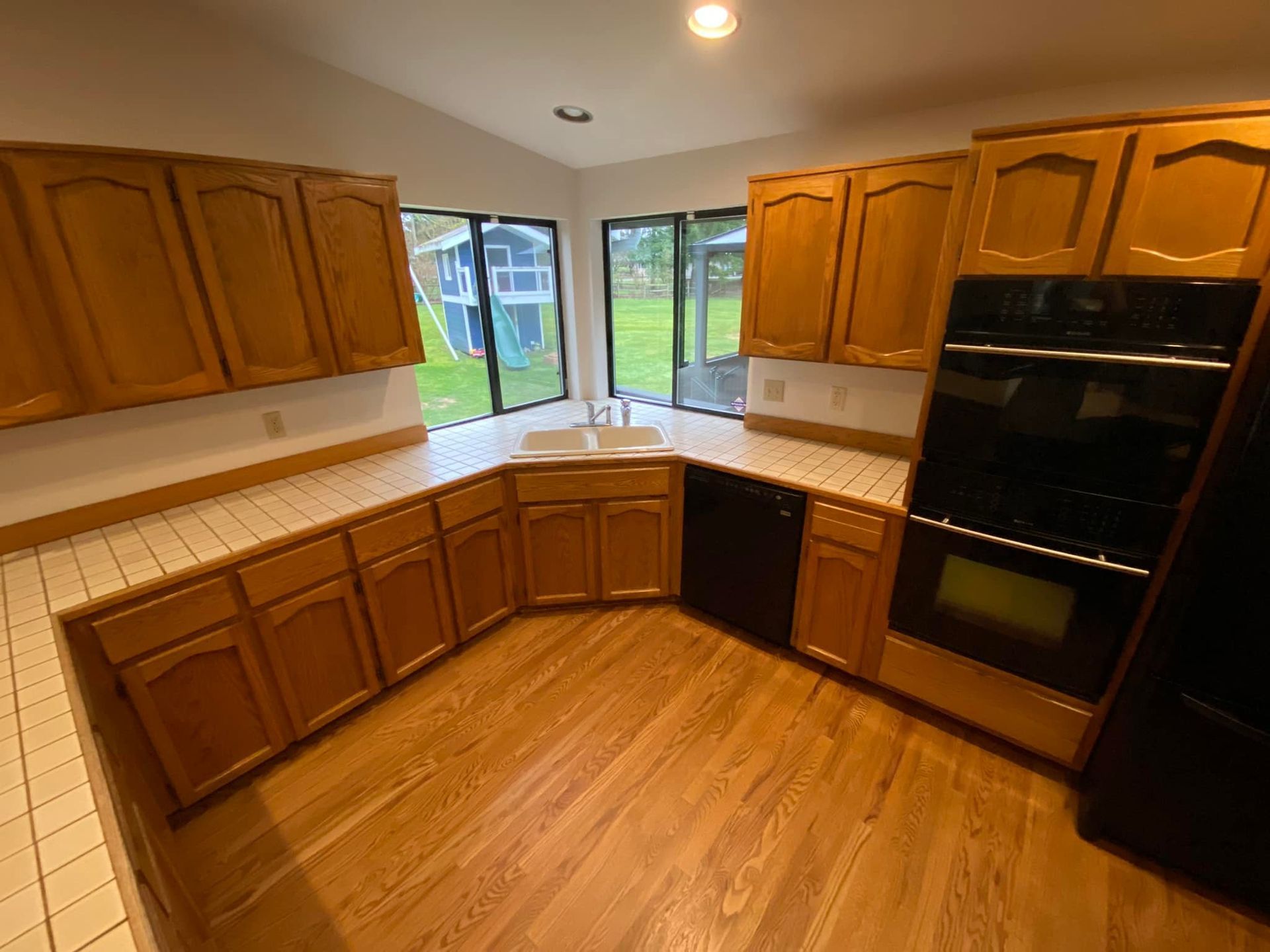 A kitchen with wooden cabinets , stainless steel appliances , and a sink.
