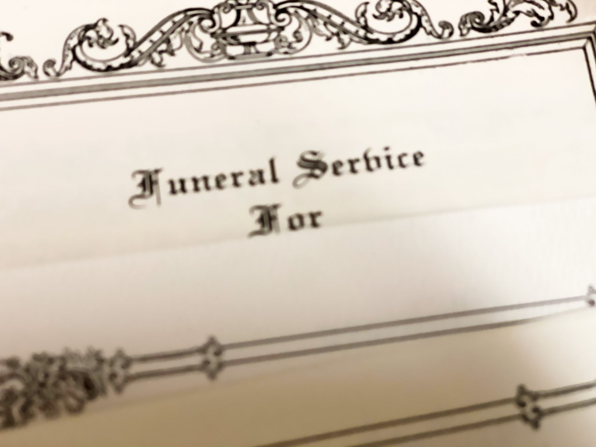 Funeral service program with ornate border, text 