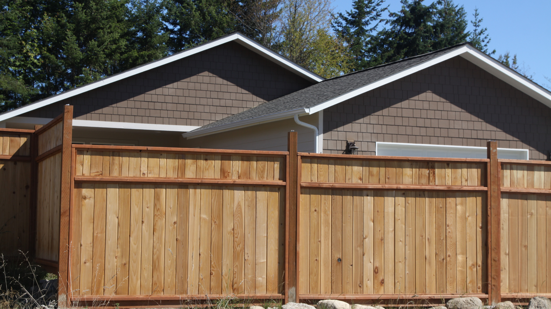 A house with a wooden fence in front of it
