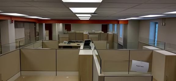 A row of cubicles in a large office building