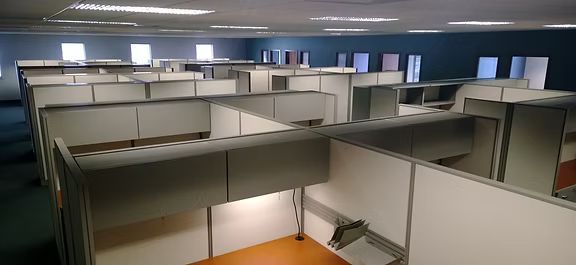 A large room with a lot of cubicles in it