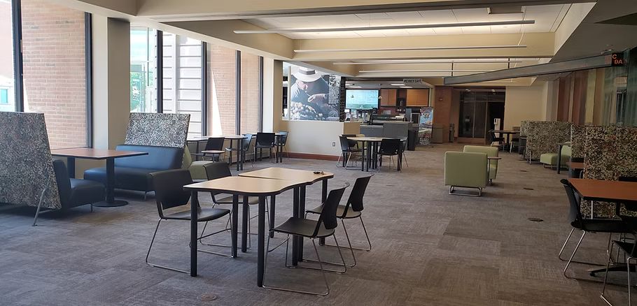 A large room with tables and chairs in it.